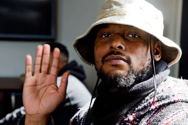 Schoolboy Q looking hot with his hand in the air.jpg