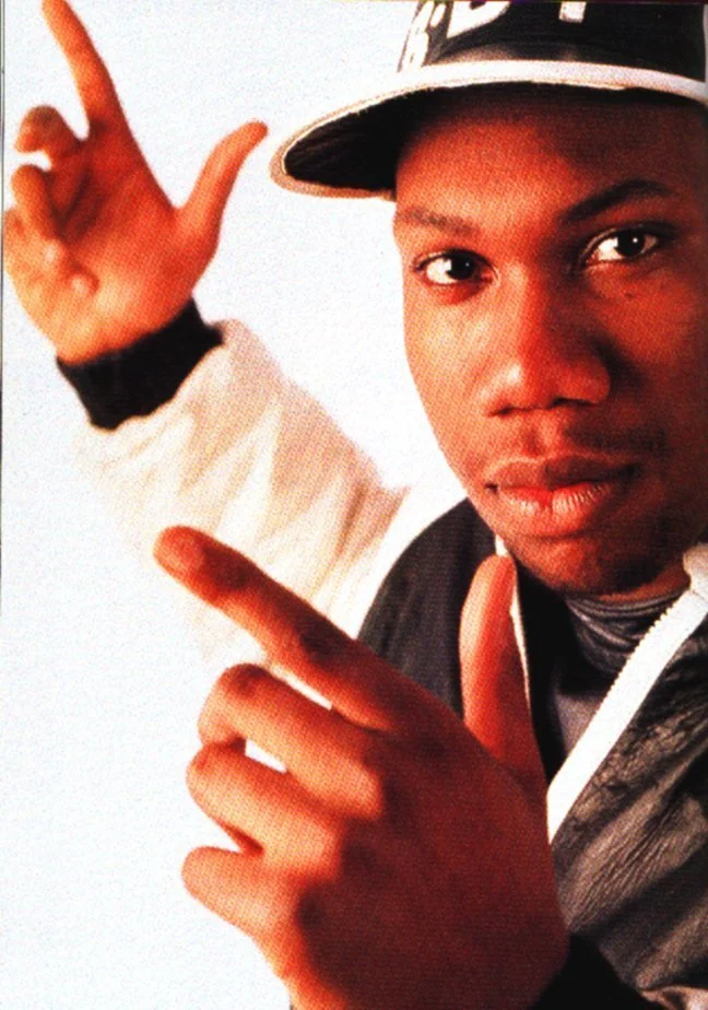 KRS-One looking hot with a hat on and his fingers up in the air.jpg