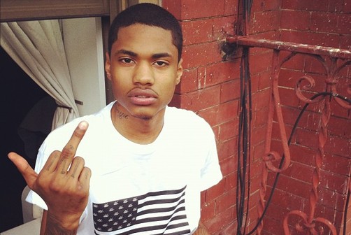 A$AP Dom giving the finger outside of a window on a fire escape.jpg