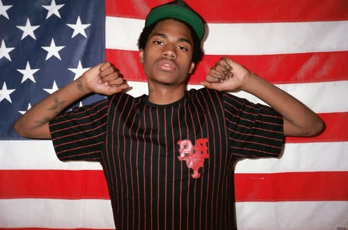 A$AP Dom looking hot behind an American flag again.jpg
