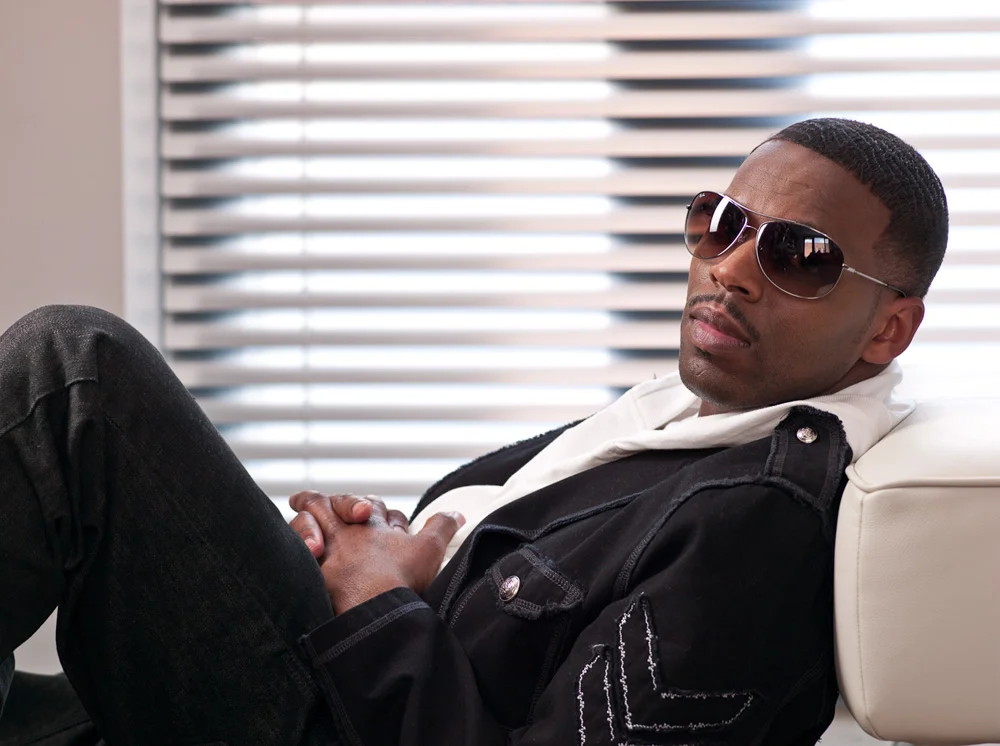 K'Jon looking hot sitting down on a white leather sofa.jpg