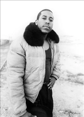 Tone Loc looking good in a wife beater and a jacket with a fur neck.jpg