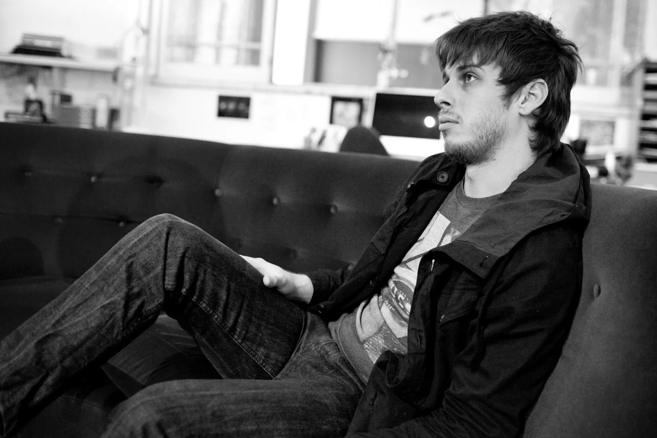 Mark Foster looking hot af on a couch in a greyscale picture.jpg
