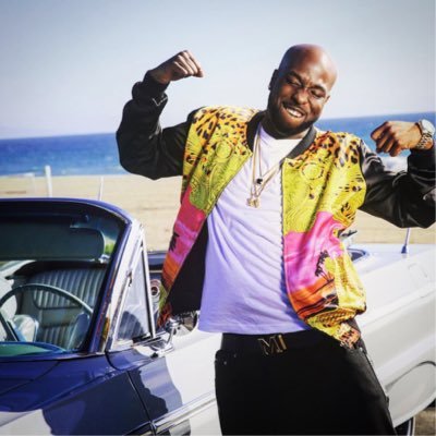 Luke Nasty on the beach flexing his muscles with a jacket on.jpg