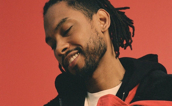 Miguel and his gorgeous smile on a red backdrop.jpg