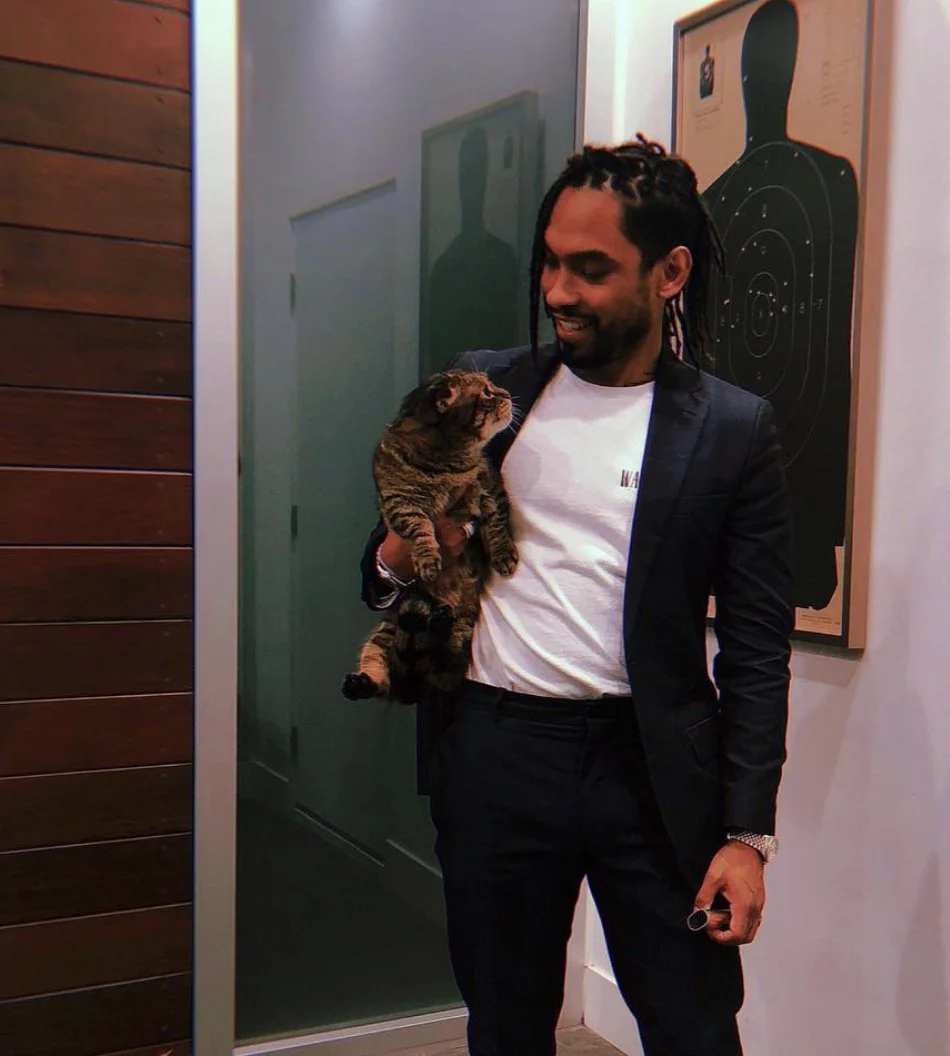 Miguel looking gorgeous whilst holding his cat Munch in his home.jpg