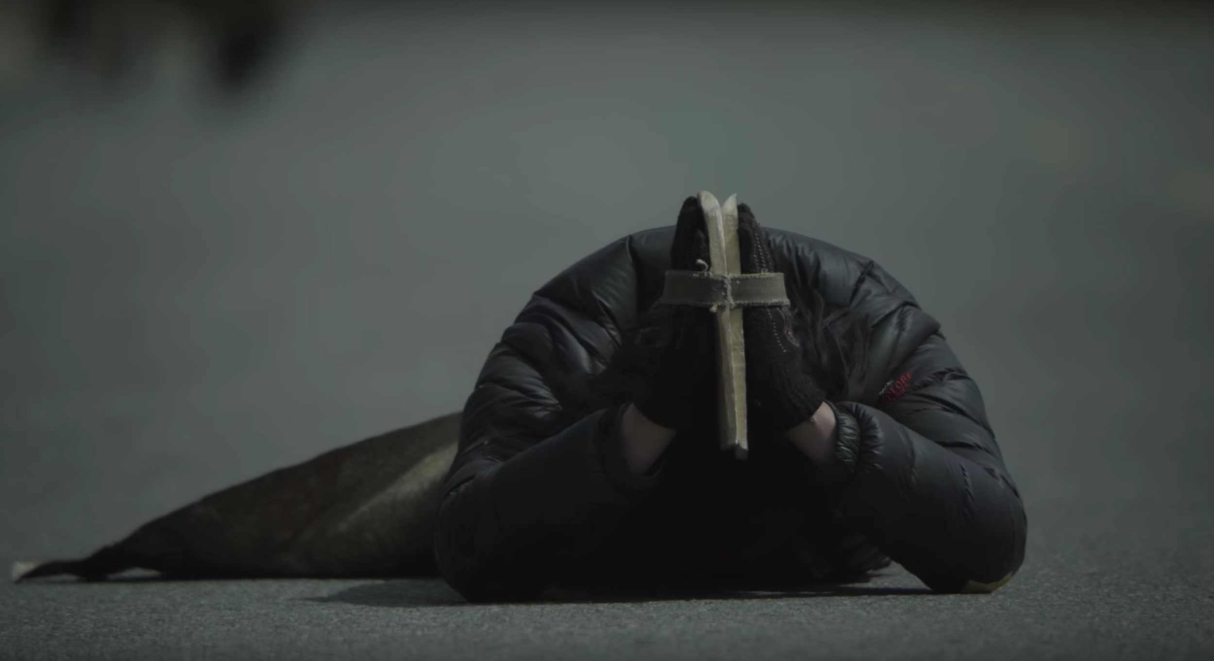 Looking a bit like a turtle, this Buddhist pilgrim prostrates himself on a road in Tibet. Note the sheep-skin aprons and wooden blocks to protect the body and the hands from the pavement.