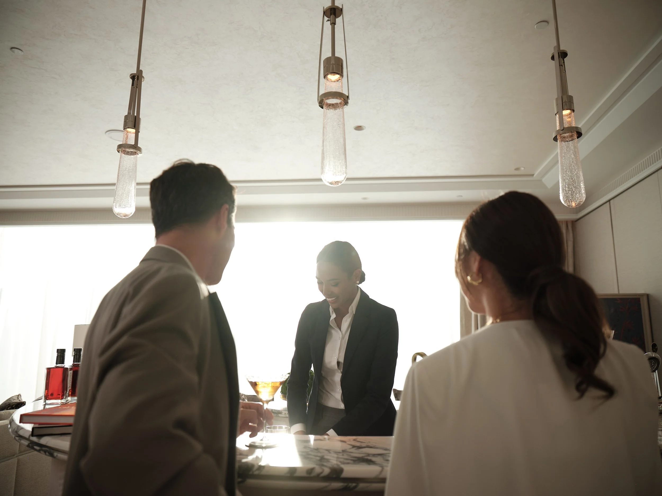20230805_MBS_LifestyleLibrary_PresidentialSuite_LivingRoom_BartenderMakingDrink_1401.jpg