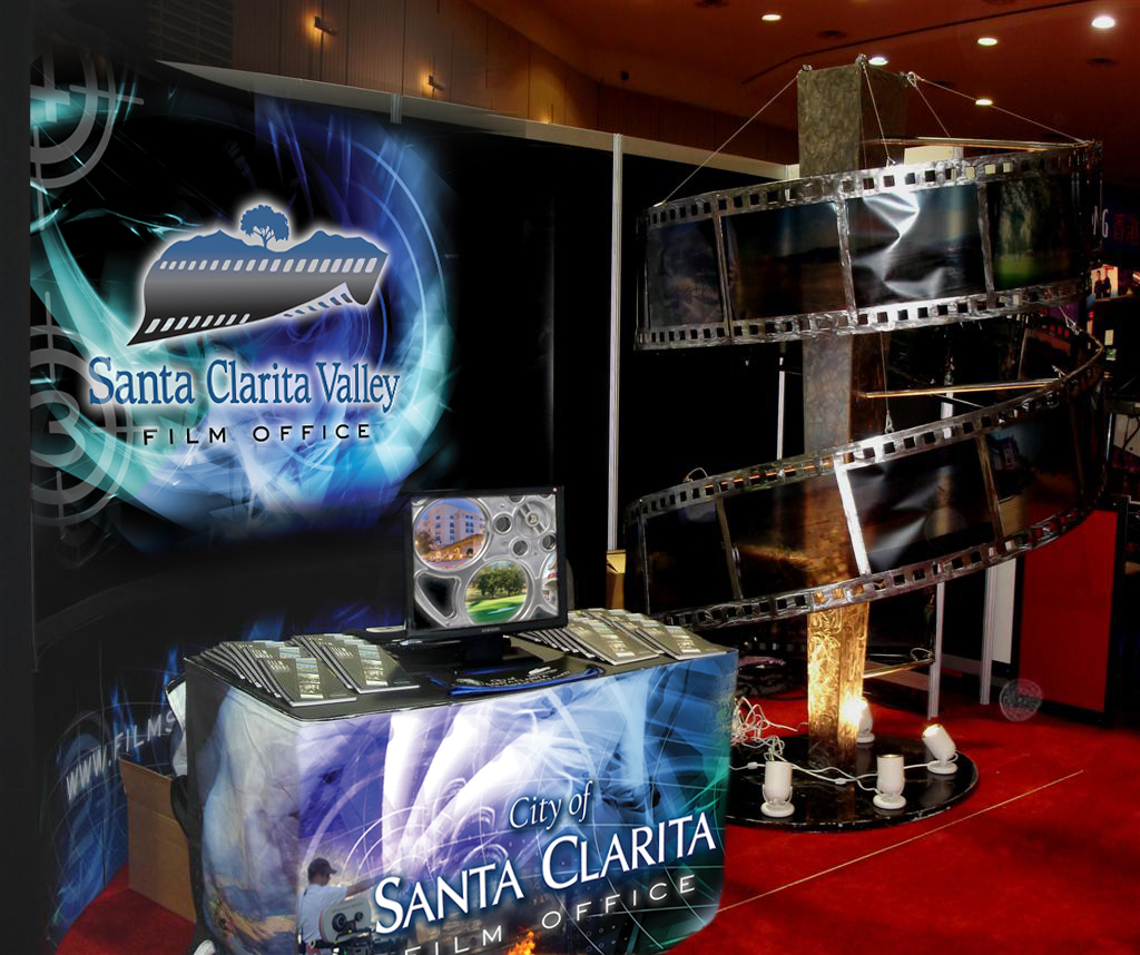 Film 20' and 10' back wall graphic, header, table banner, expanding side light panels, and sculpture.