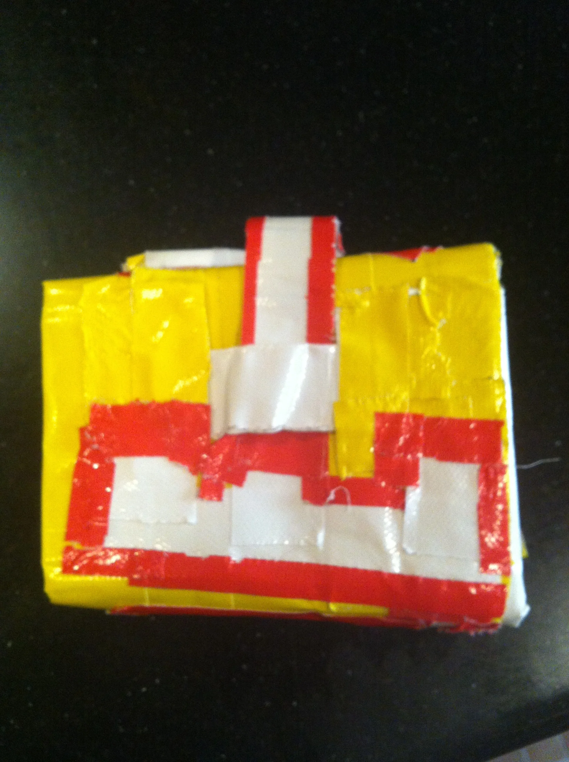 A duct tape wallet gifted to Kiddo from a little girl at summer camp. This is serious craftsmanship by a 10-year-old (it even has slots inside for pictures and credit cards, and has Kiddo's name etched out in red and white tape). I have a feeling someone is spending a lot of quality time with a Doha stay-at-home dad living out every man's duct tape crafting fantasy.