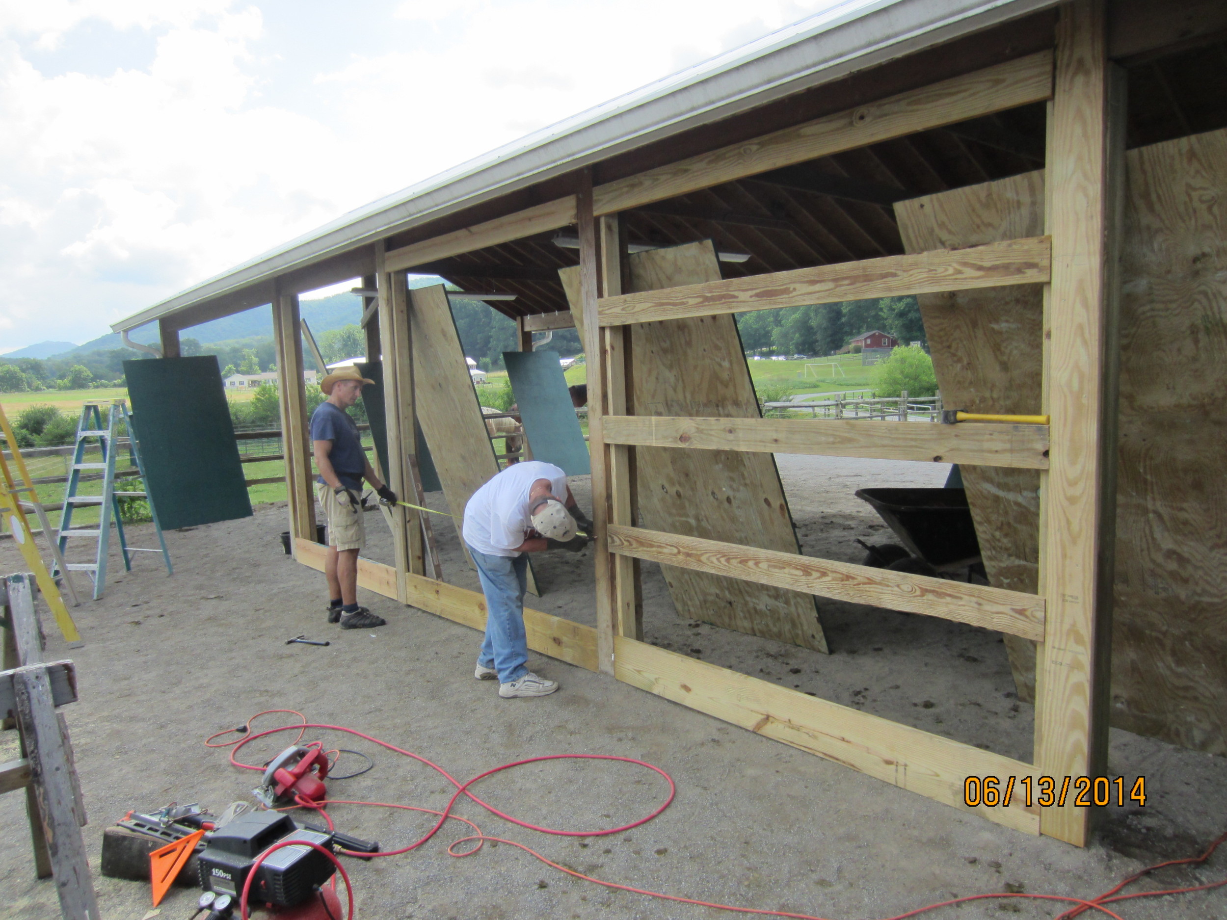 Building a curtain wall at the stables.
