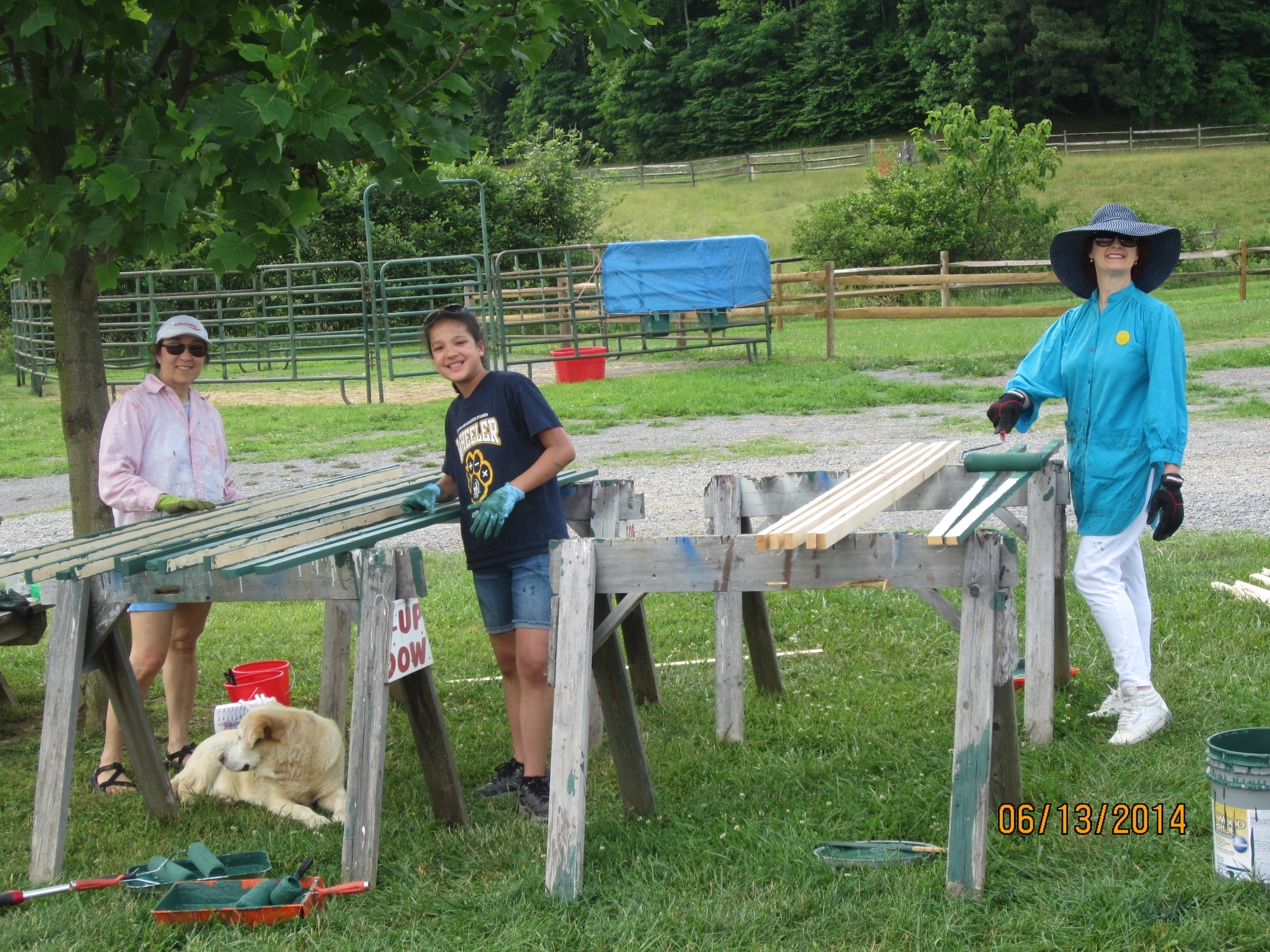Staining the curtain wall trim. Nellie More, Abbey Mayfield and Carol Johnson.