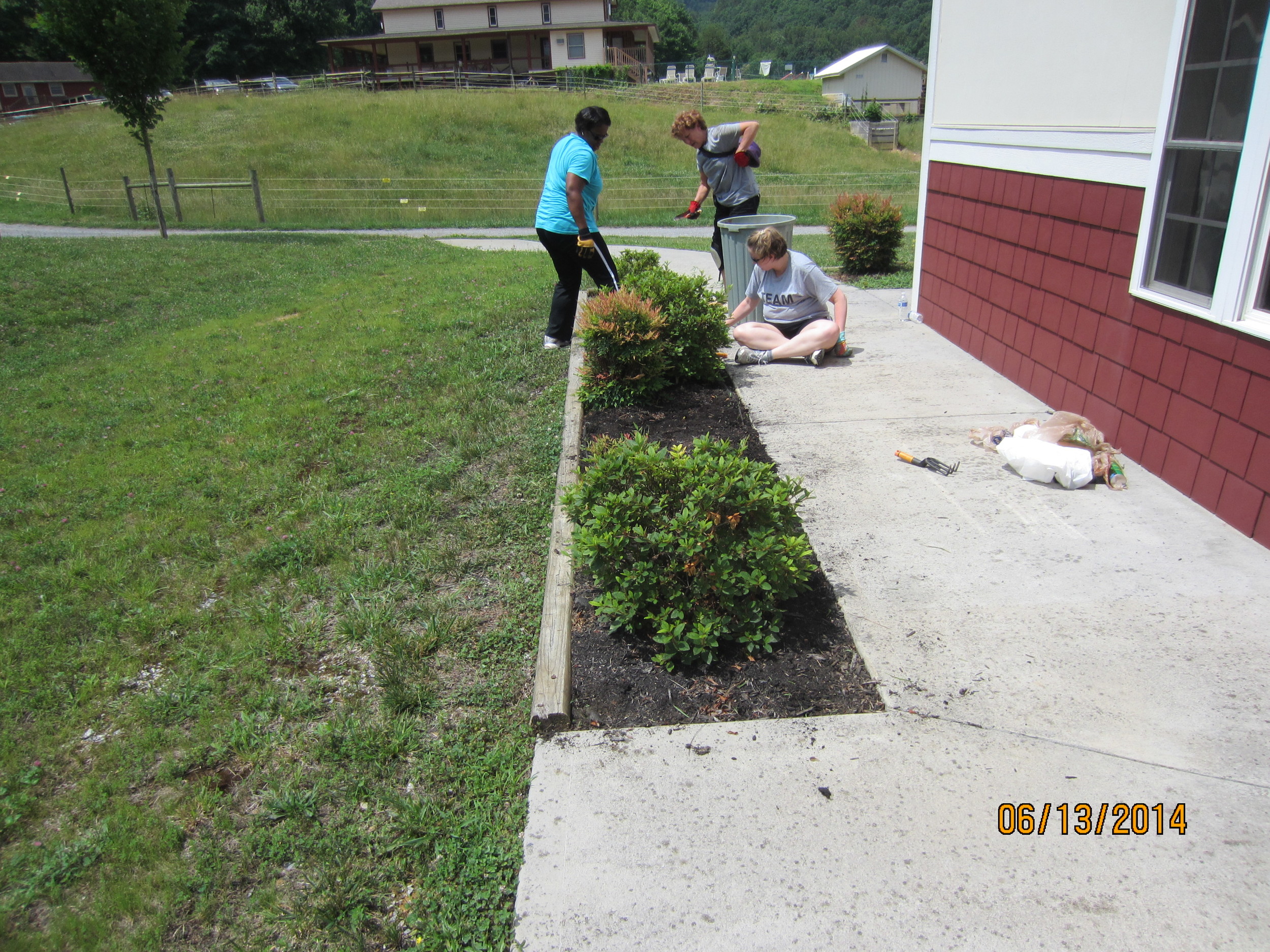 More weeding at the science building, Demetria Utley, Lauren Pearle and Nanci Scott.