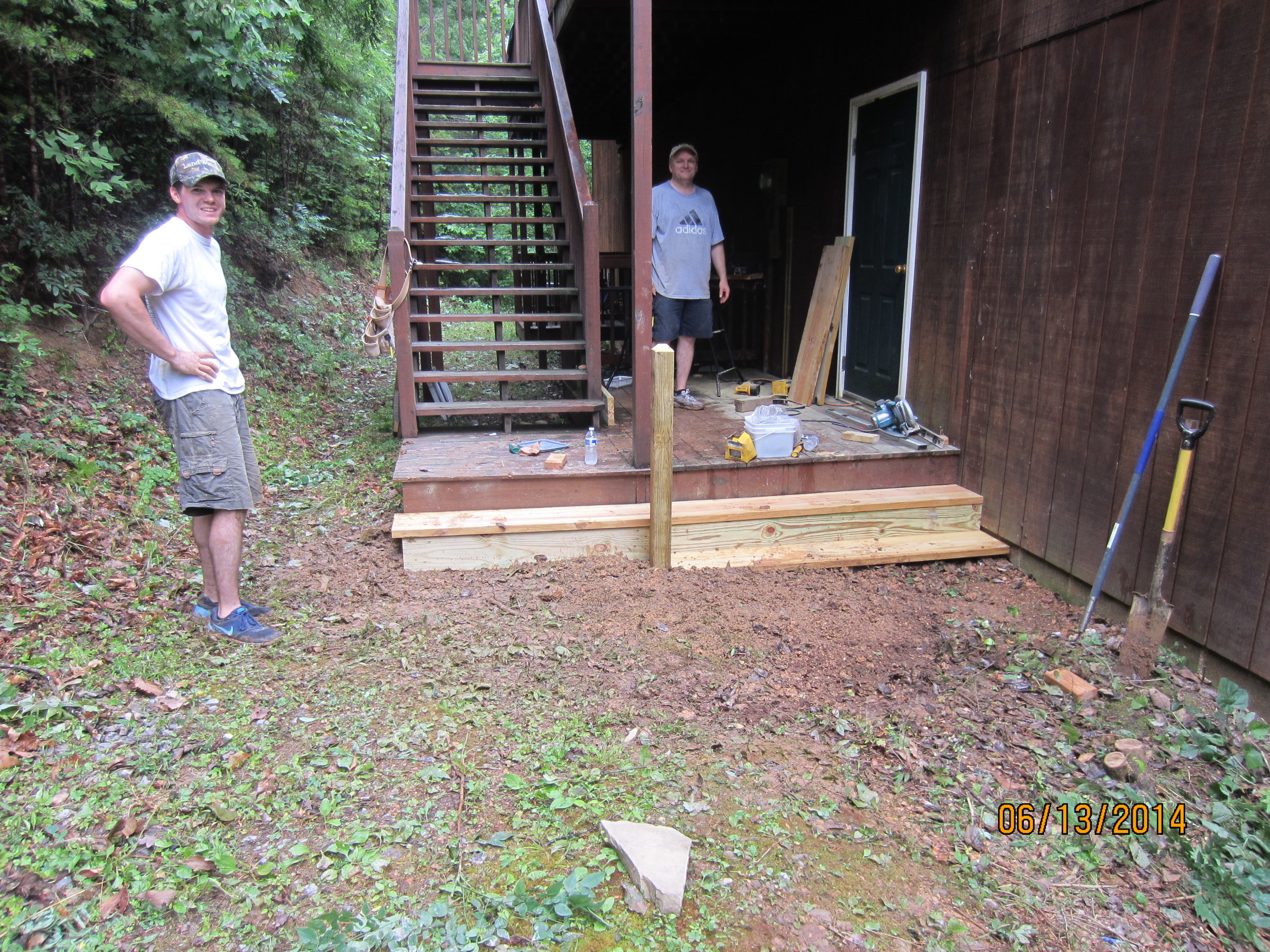 Philip and Evan Stout finishing up the new steps for the back of the Dormitory building.