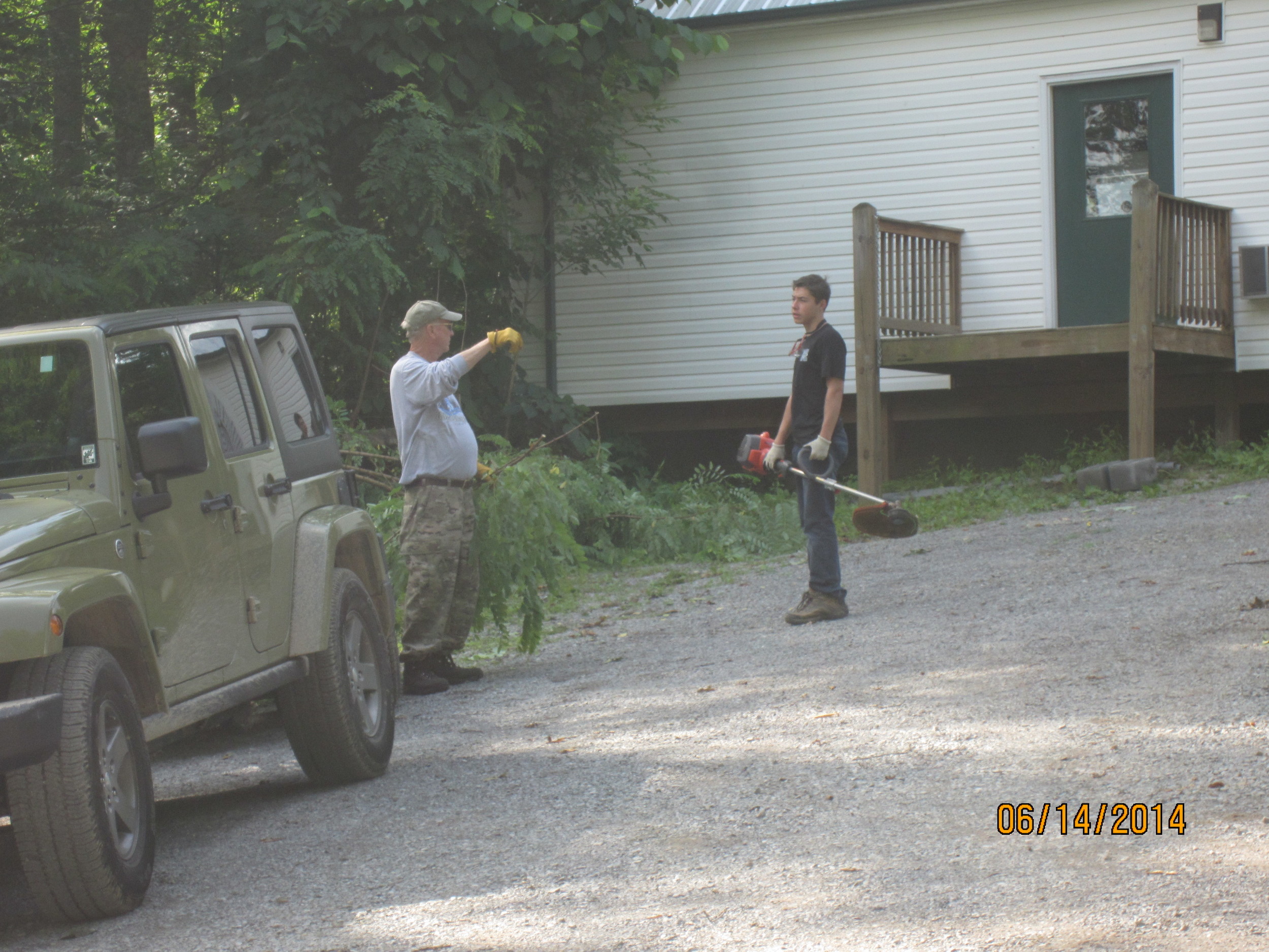 Jim Bishop and Nick Cheater continue doing landscaping duties near the Dining Hall.