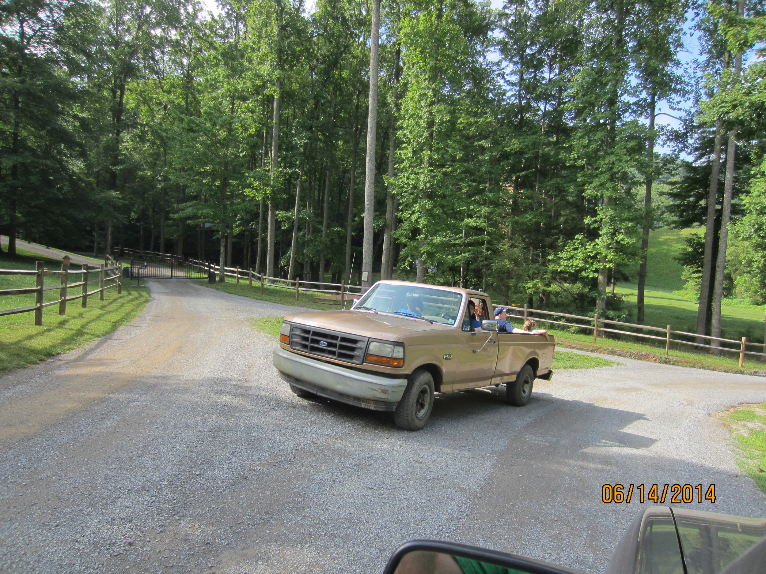 The mulching crew en-route from the Lake House to the Dining Hall, Pierce White is driving with members of the Reid Family in the back.