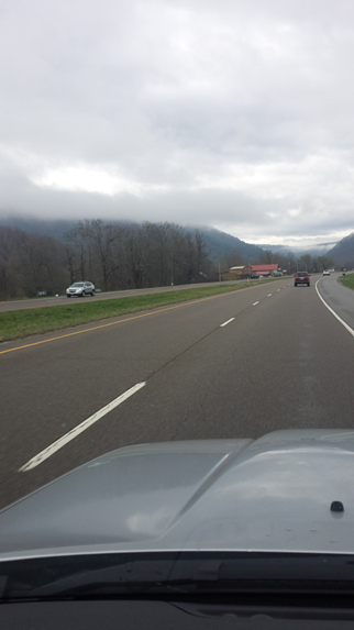 The morning fog looks like smoke rising from the mountain ranges.
