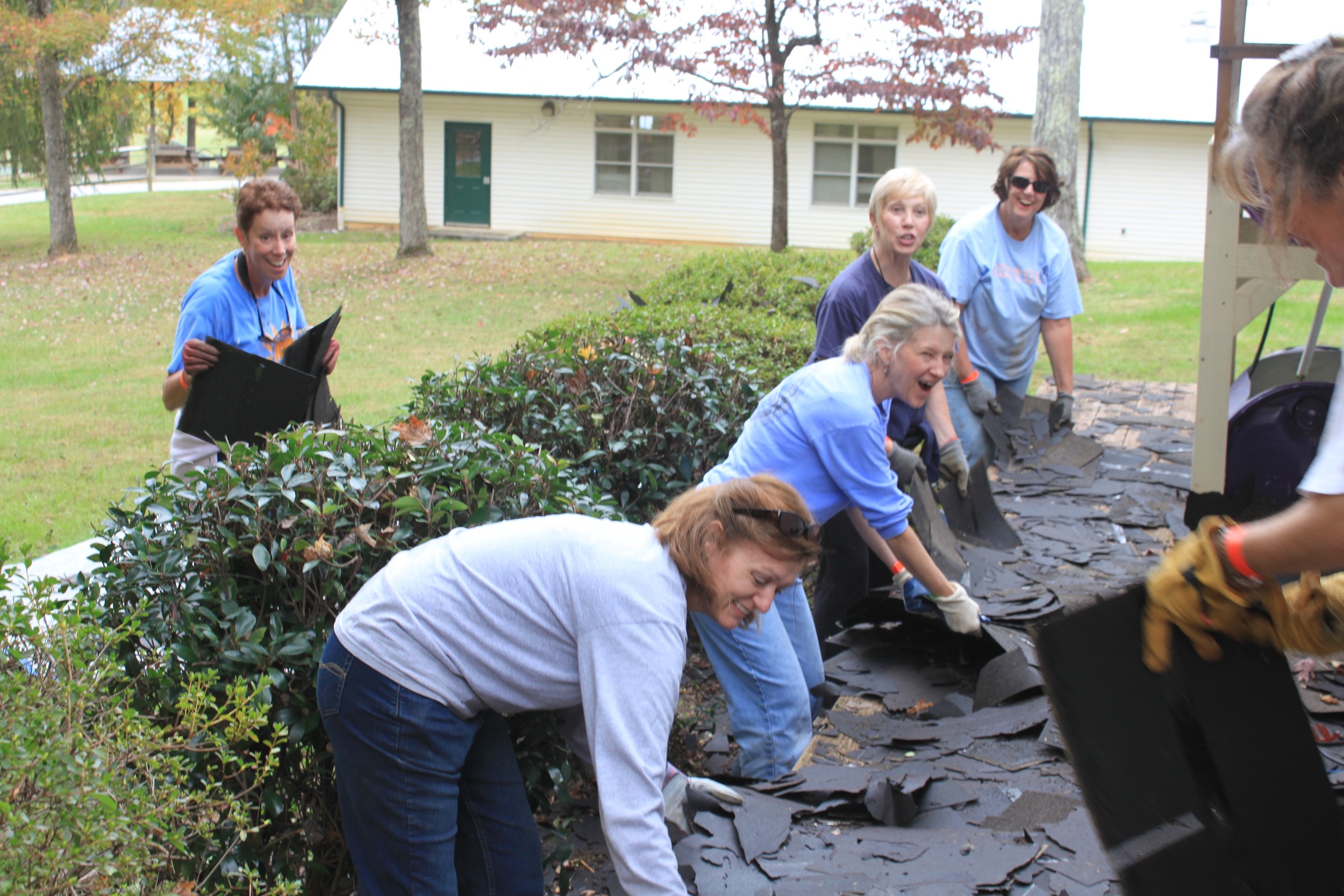 The flexible staining team took on the challenge to transport all of these shingles to the dumpster.