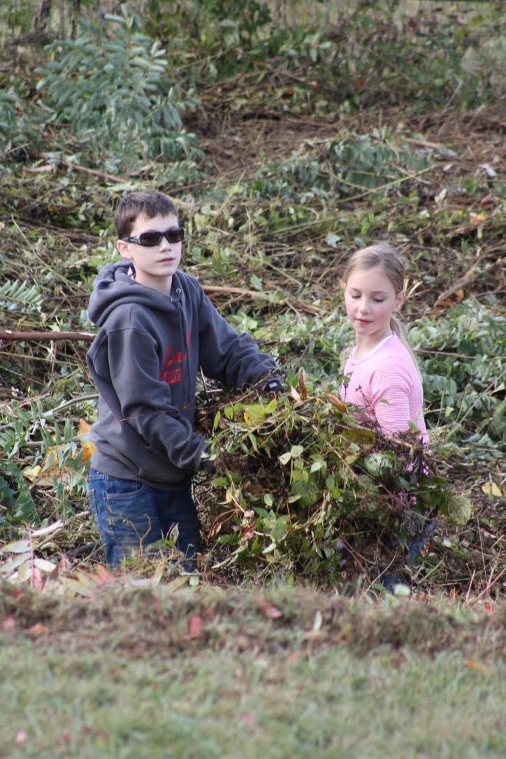 Brother and sister helping clear out the creek banks...