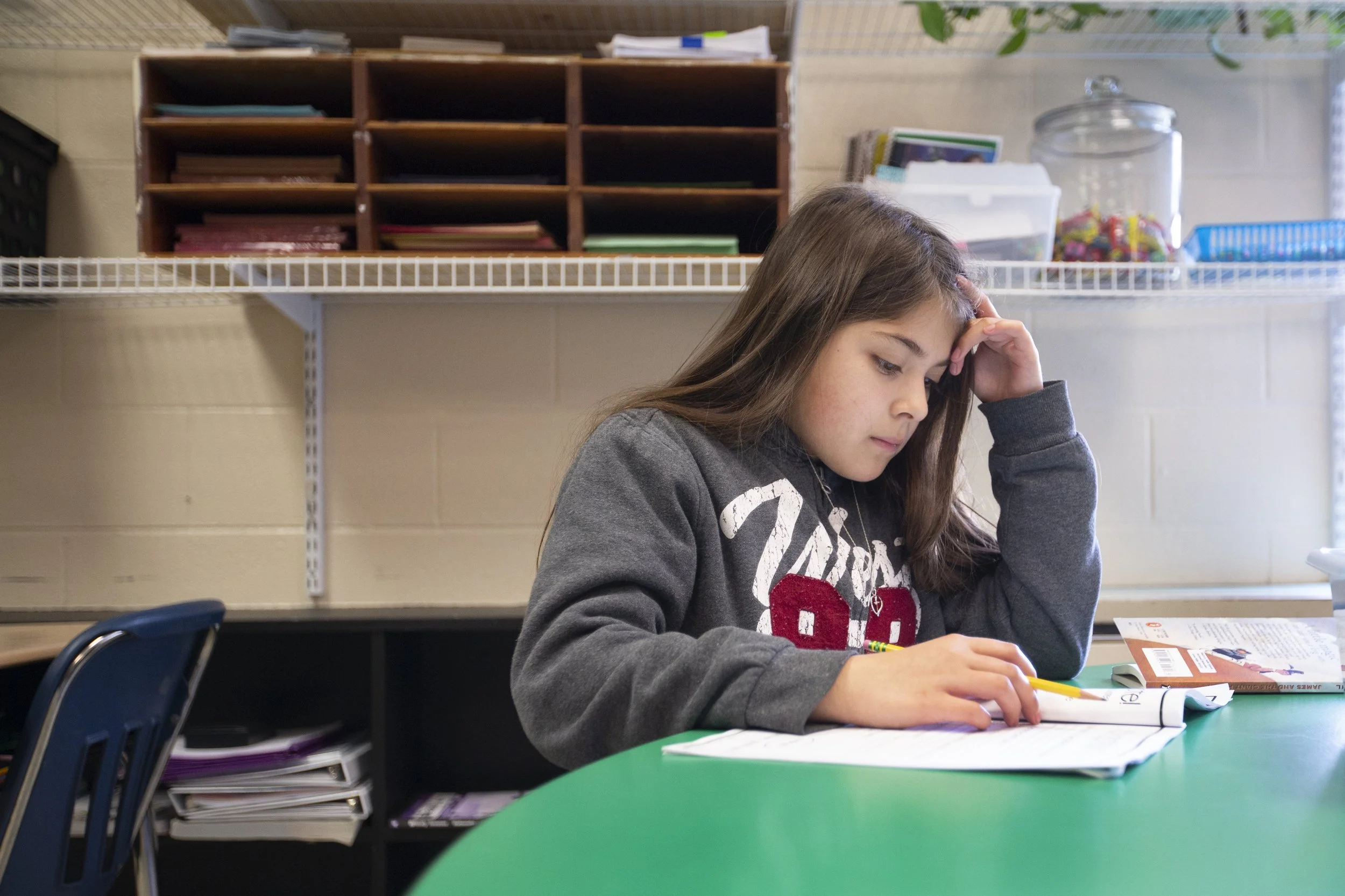 Kanya Smith, 9, reads a book for an assignment at McDowell Elementary School in Columbia, Tenn, on Monday, April 19, 2021.