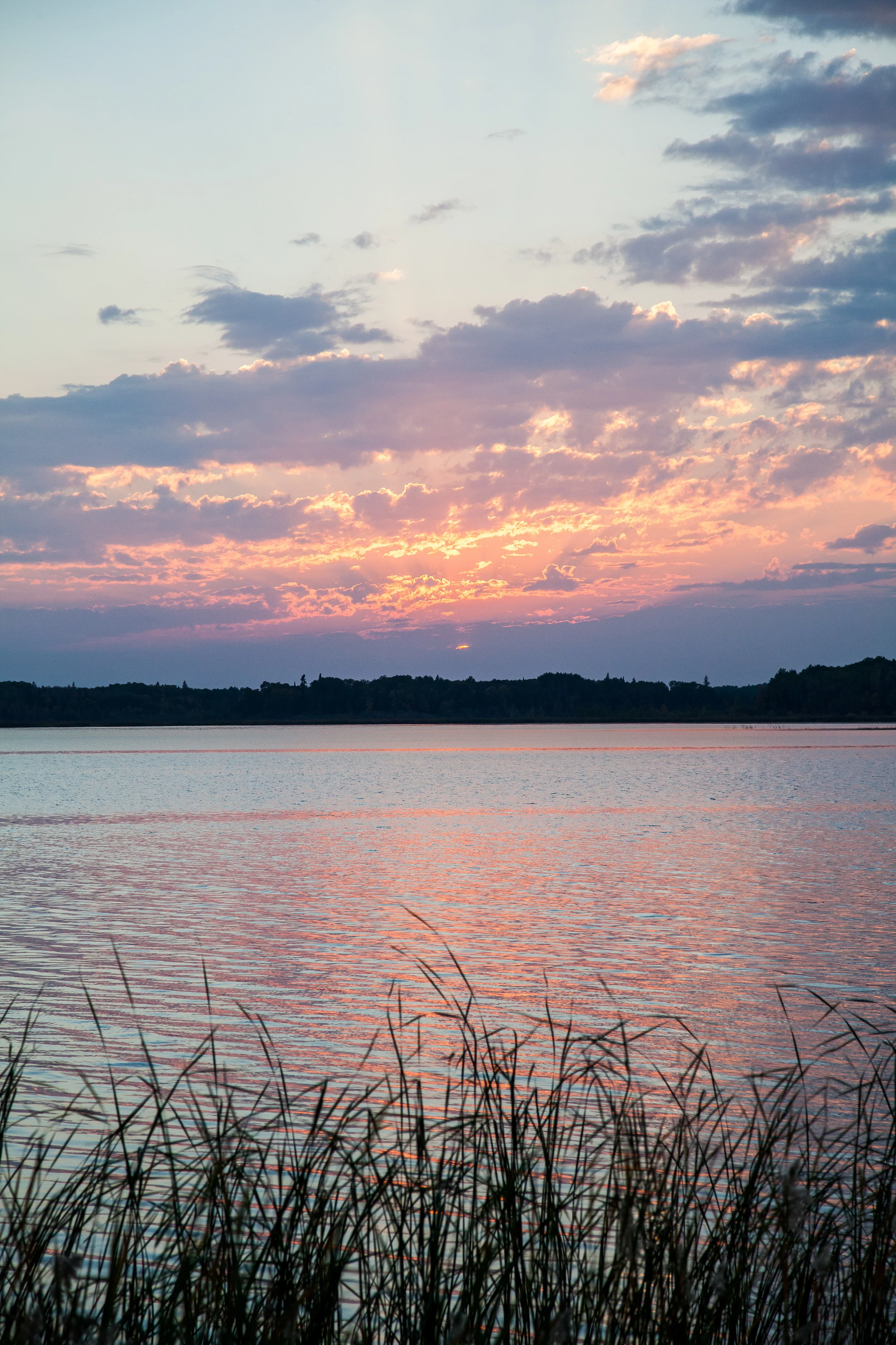 The sun sets over Snow Shoe Bay. The water in this part of Shoal Lake is heavily polluted. Viewed closesly it has a reddish tinge, and a noticeable smell. Swimming or washing in it causes one to break out with rashes and blisters. It cannot be drunk and Shoal Lake #40 lacks a proper water treatment centre.