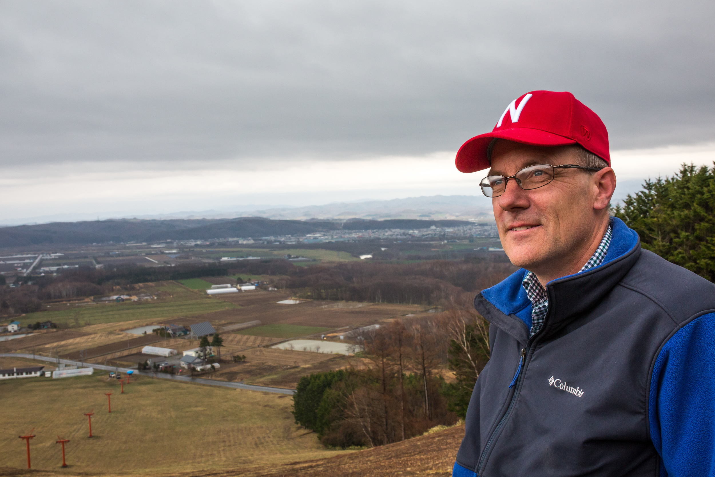 Ray Epp stands atop a ski hill in Naganuma, Japan overlooking his farm, Menno Village.