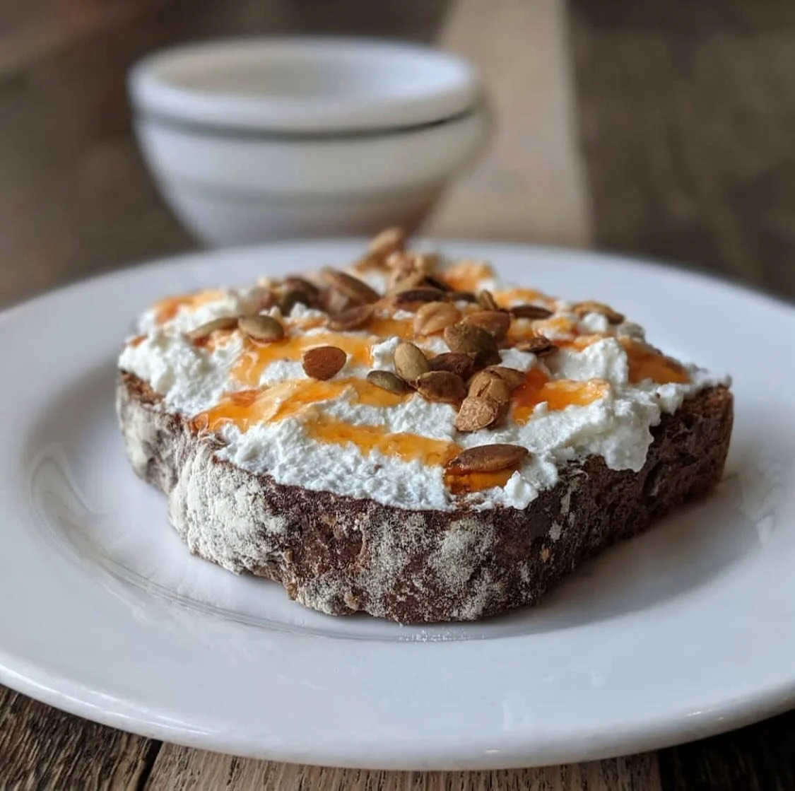 Ricotta toast is back!! 
Ricotta, hot honey, and toasted pepitas on our multigrain bread. Come try a slice!
