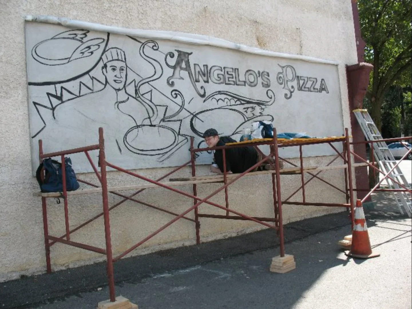  Painting the guide for the Angelo’s Pizza mosaic mural.  Photo by  Art for Auburn    