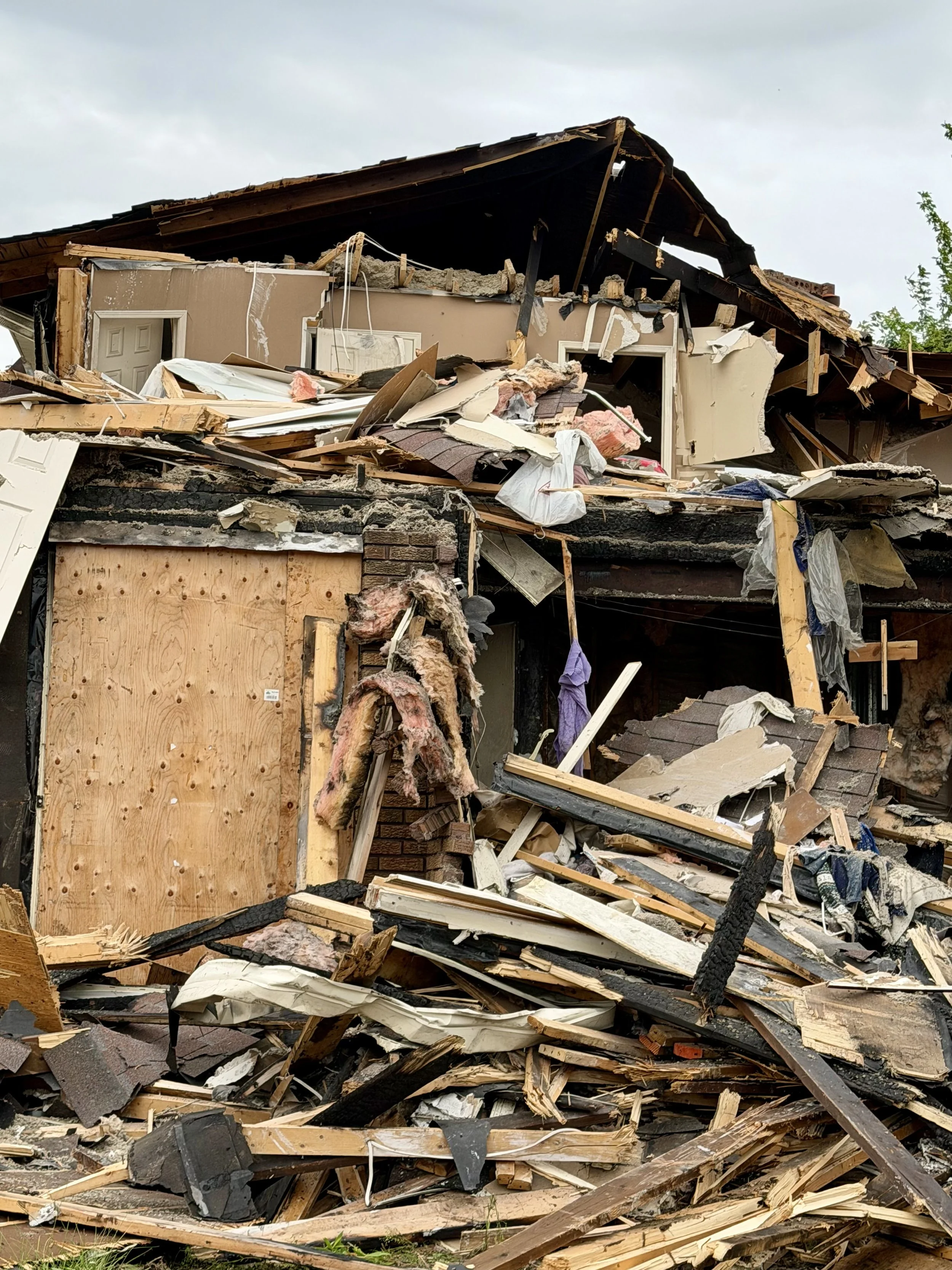 Demolition crews work to clear away the remains of the long-standing fire-damaged home on Woodglade Boulevard. (Photo by Scott Arnold)