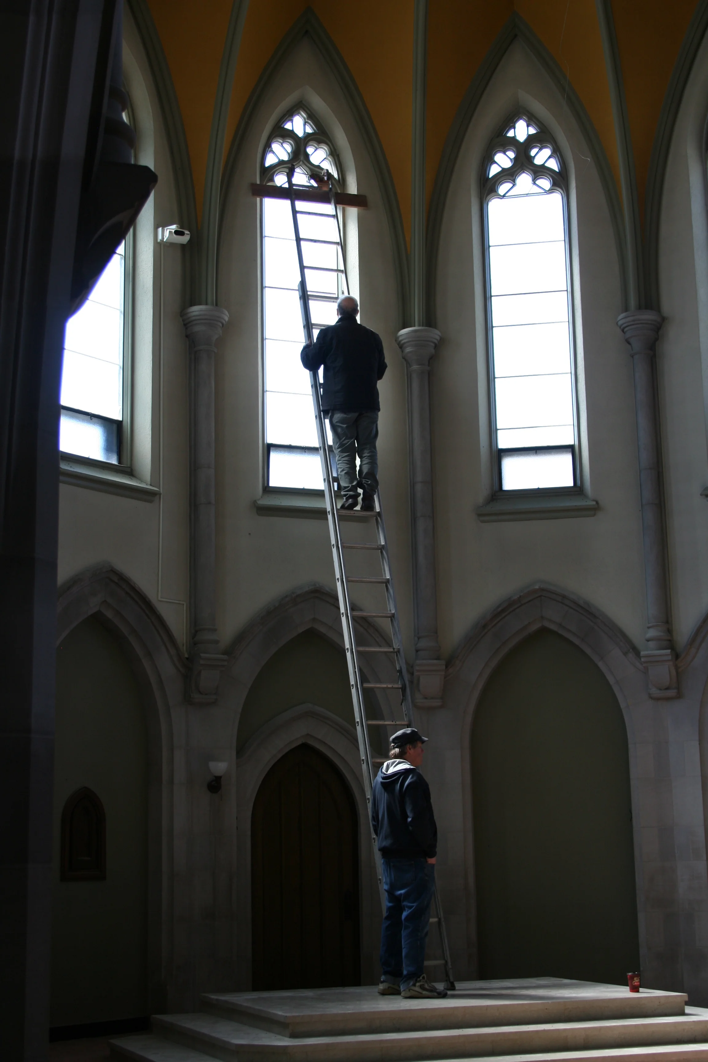 Public Energy Artistic Producer Bill Kimball helping Artist Robert Edmonson install his kinetic sculpture in the Chapel. Photo: Paul Oldham