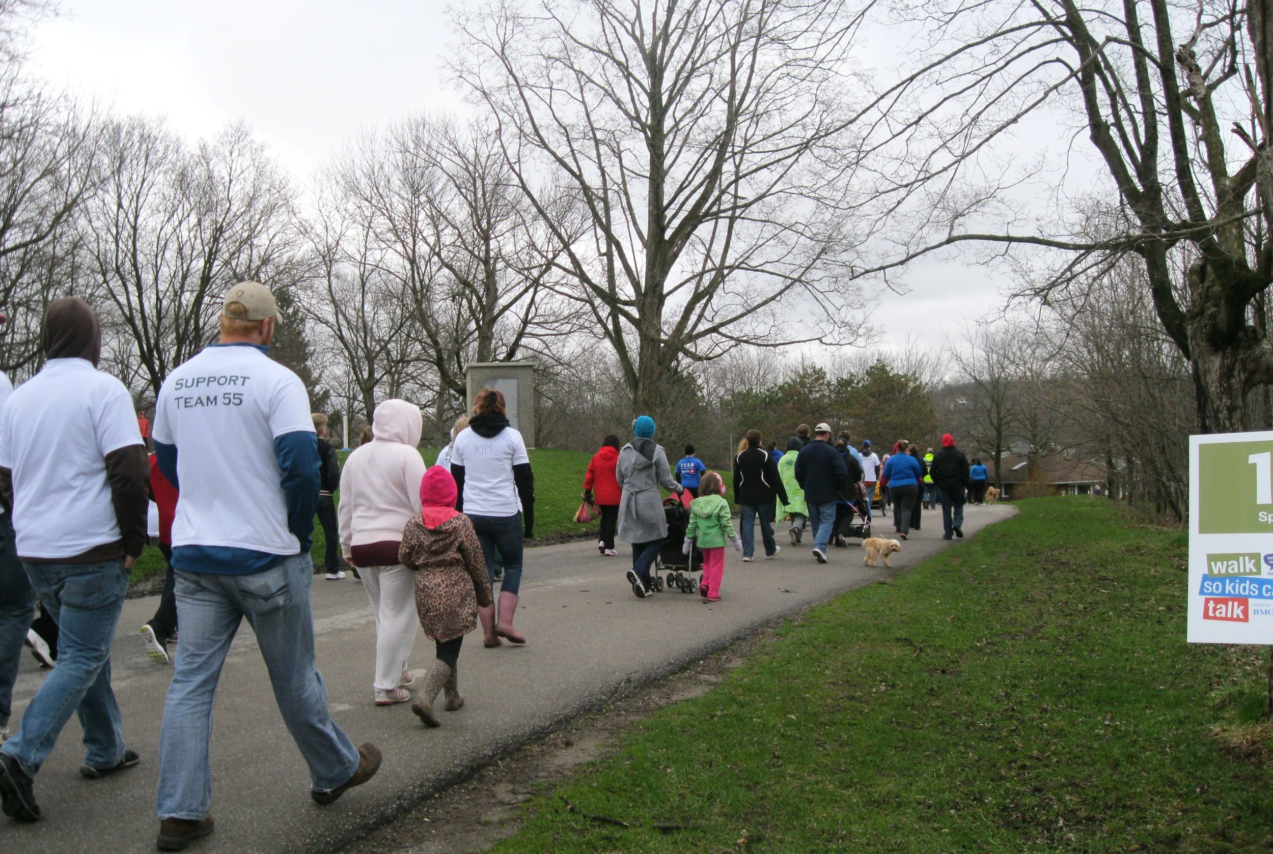 Adults, kids and pets alike take off for their first kilometer of the walk