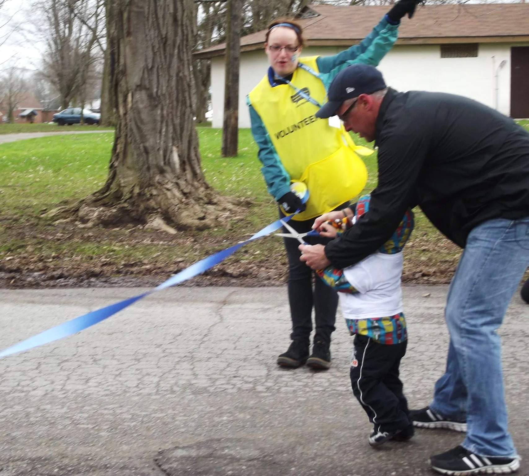 David Pogue of Team 55 and his grandson cut the blue ribbon to mark the official start of the walk and honour his son Mitchell