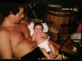 Mark holding his baby Ashley at 6 months