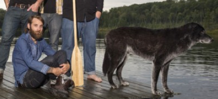 Simon pictured with a paddle & a dog