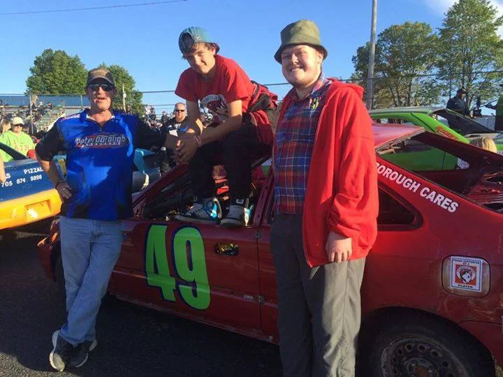 Dave Tuck pictured with his boys Criss and Jeffrey (and Criss's race car)
