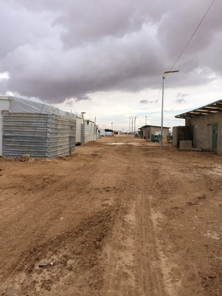Above left: Some of the caravans within which people live at the refugee camp. Above right: communal bathrooms