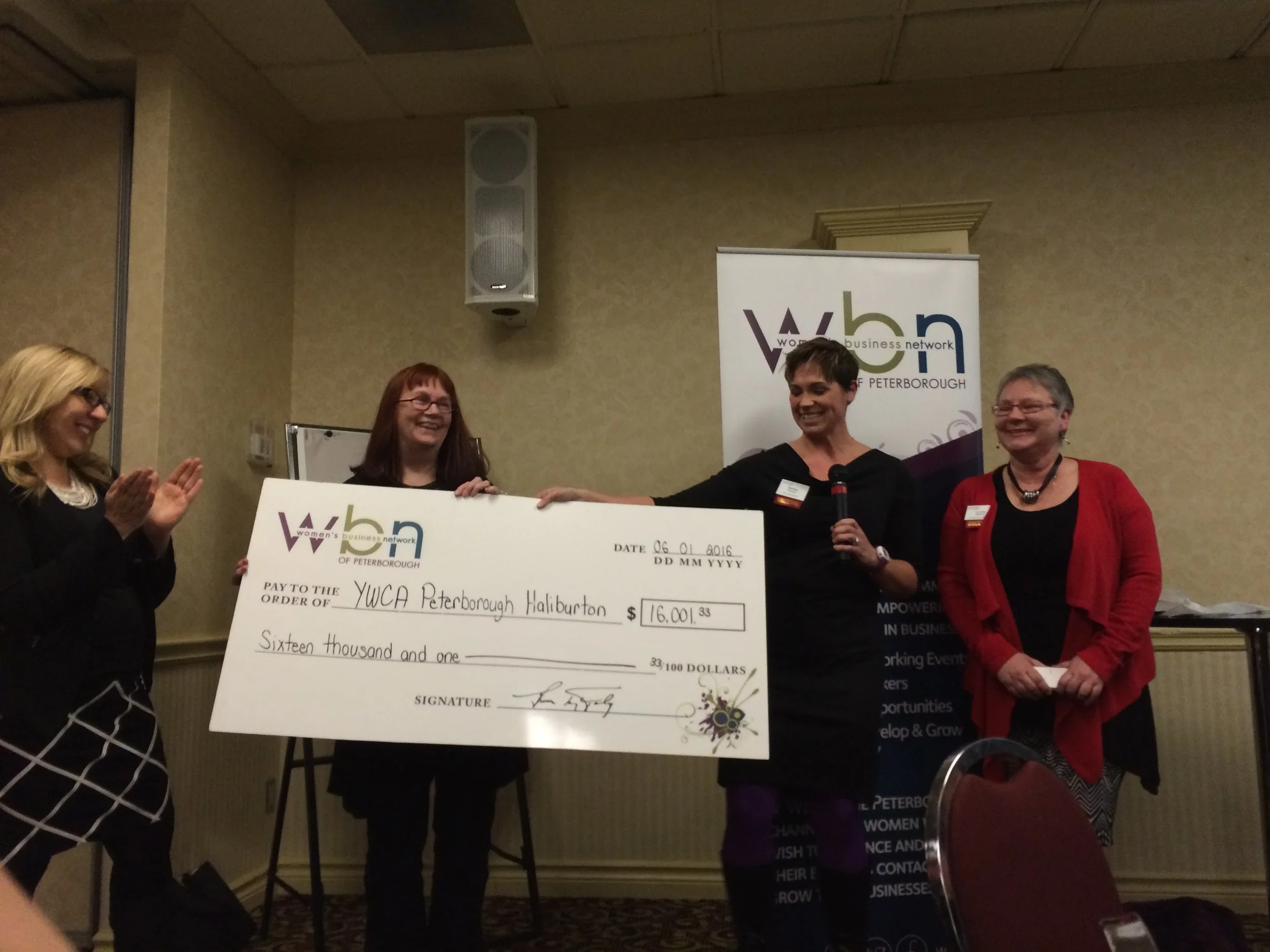 YWCA Executive Director Lynn Zimmer accepts cheque