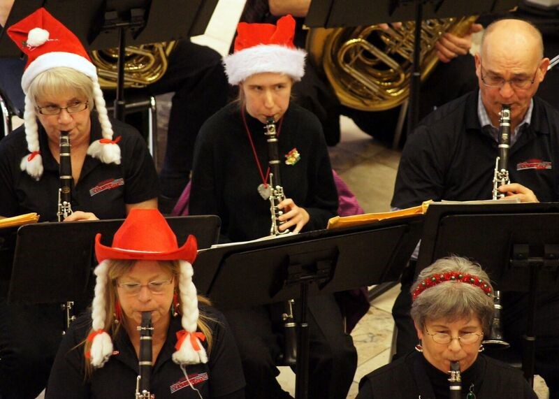Members of the band get into the holiday spirit at a free concert at Peterborough Square before the Santa Claus Parade