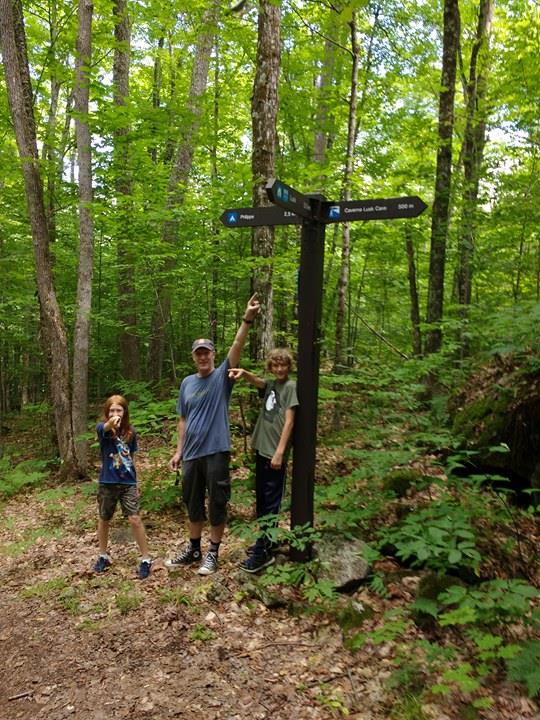 Jim, Charlotte and Alexander pictured on the Lusk Cave trail shortly after meeting the Trudeaus