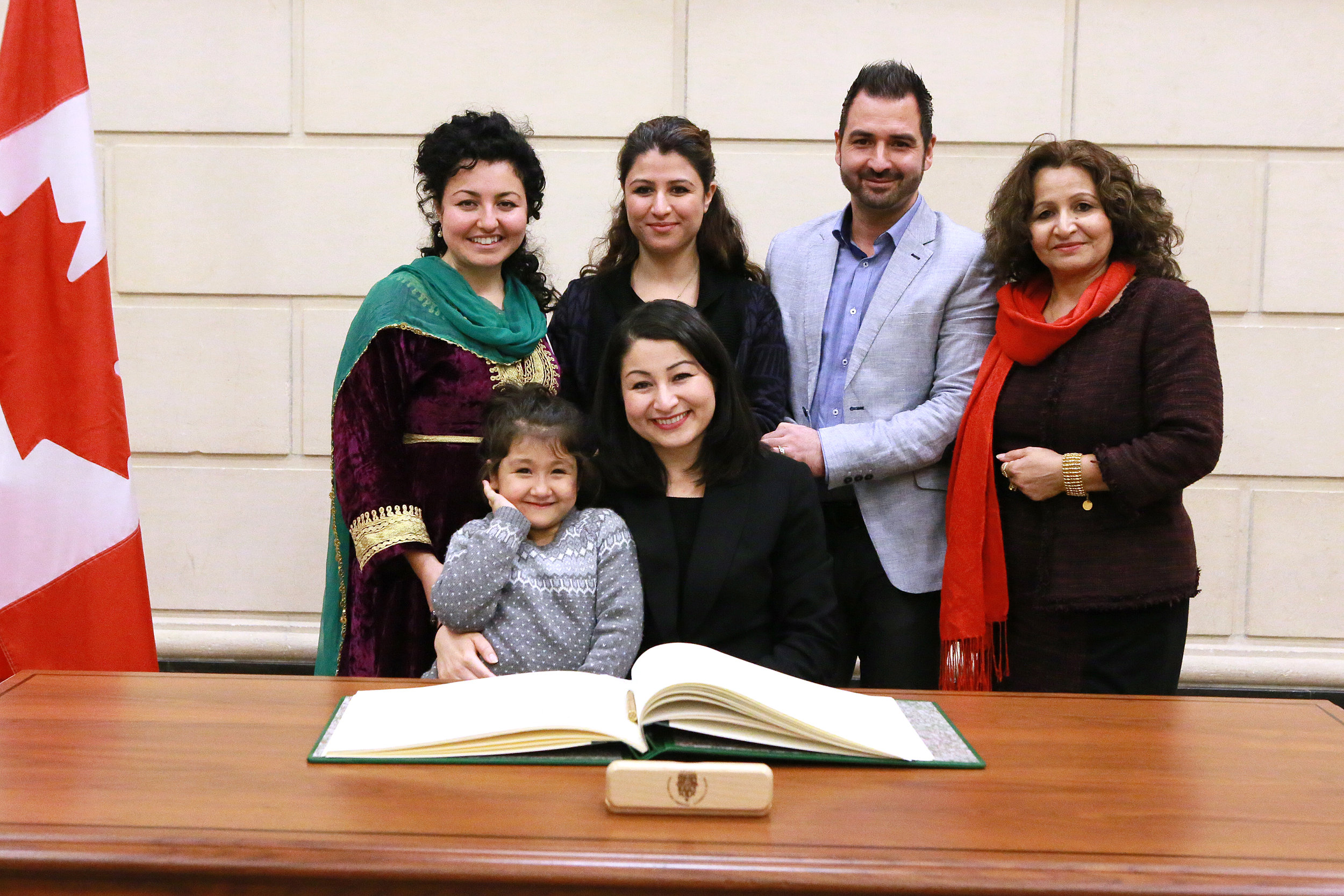 Photograph of Maryam with her family. The photograph was taken at her swearing-in ceremony as the Member of Parliament for Peterborough-Kawartha, which occurred at the House of Commons on November 24, 2016. Clockwise starting on the left: the family are Mehrangiz Monsef, Mina Monsef, Mehdi Taheri (Mina’s husband), Soriya Basir-Monsef, Maryam Monsef, Leila Taheri (Mina & Mehdi’s daughter).