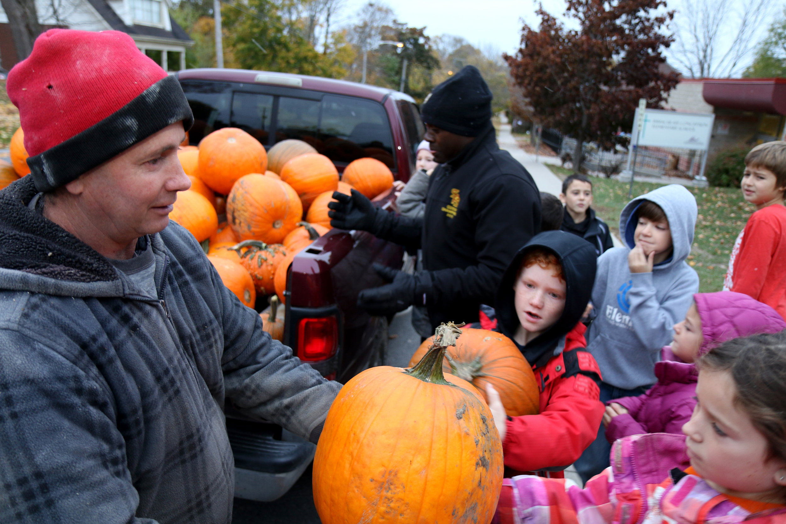 Peter Leahy and Louis giving out pumpkins to the kids