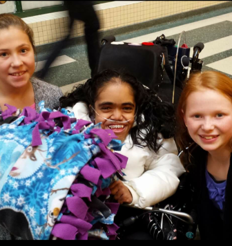 Faith delivering cuddle blanket to patient