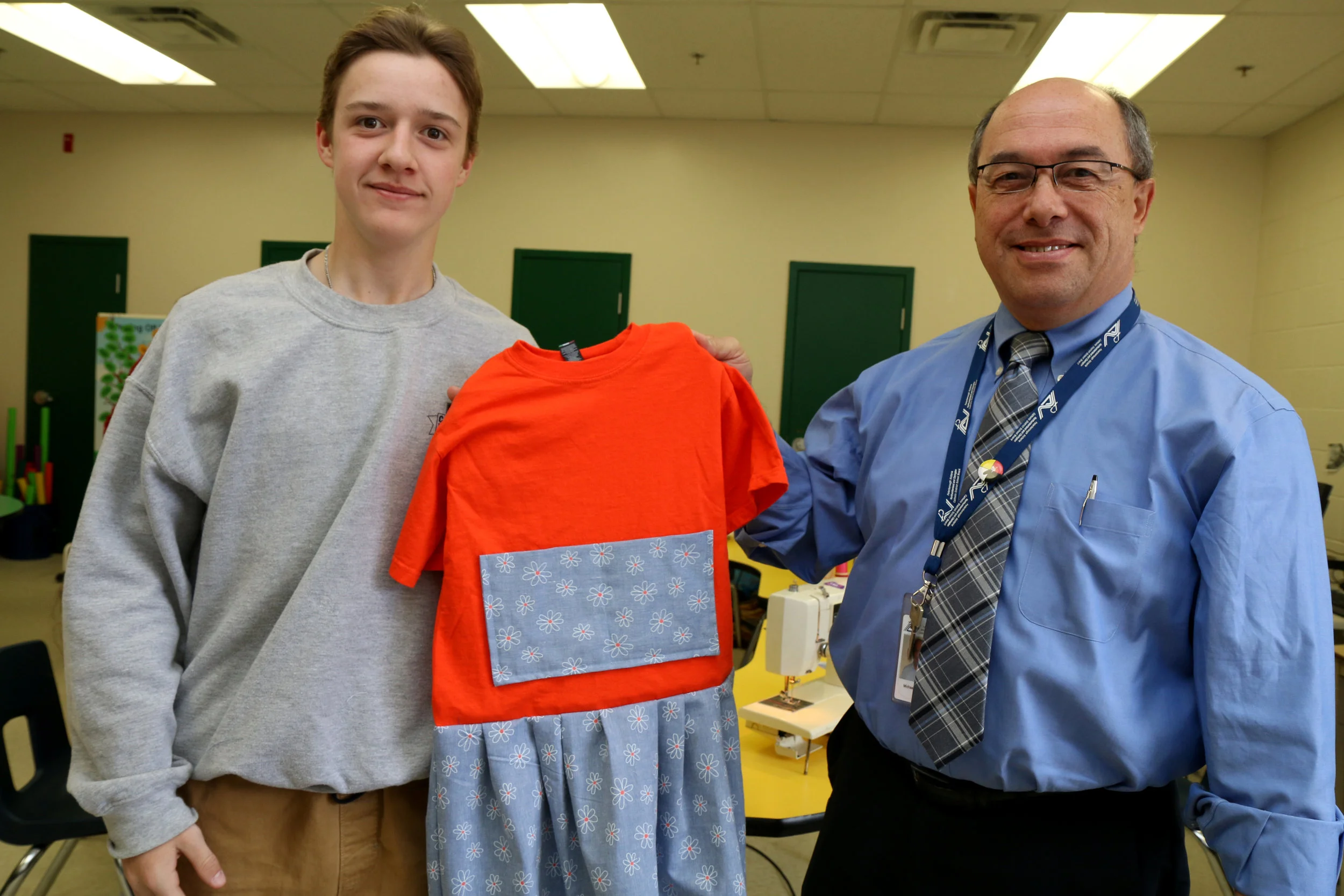 Director of education Michael Nasello shakes hands with sewing partner Grade 8 John Hughes