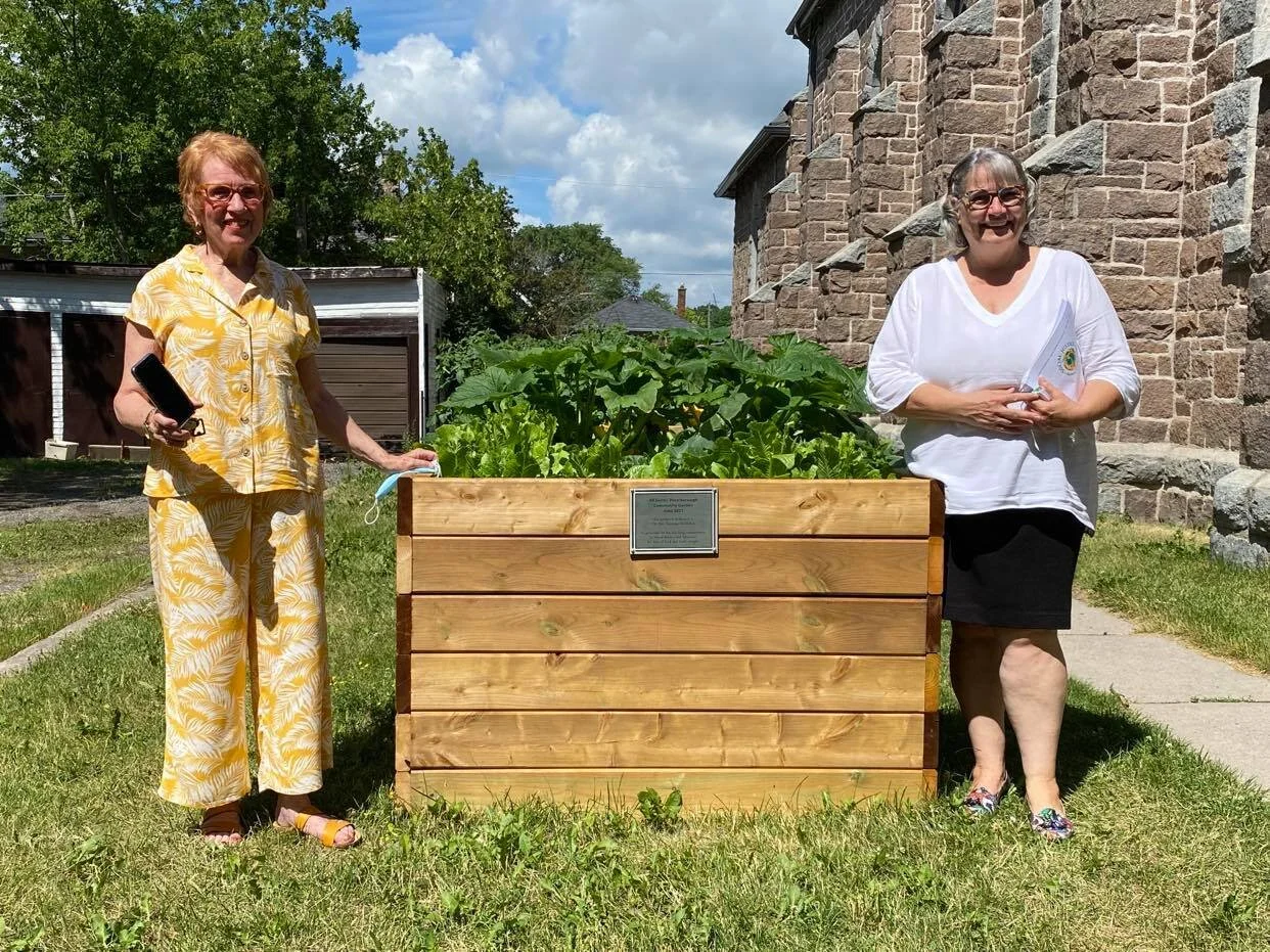 Reverend Suzanna McMillan (left) and Reverend Samantha Caravan (right) in front of one of five vegetable garden boxes that will continually grow crops for local communities. Photo by David Tuan Bui.
