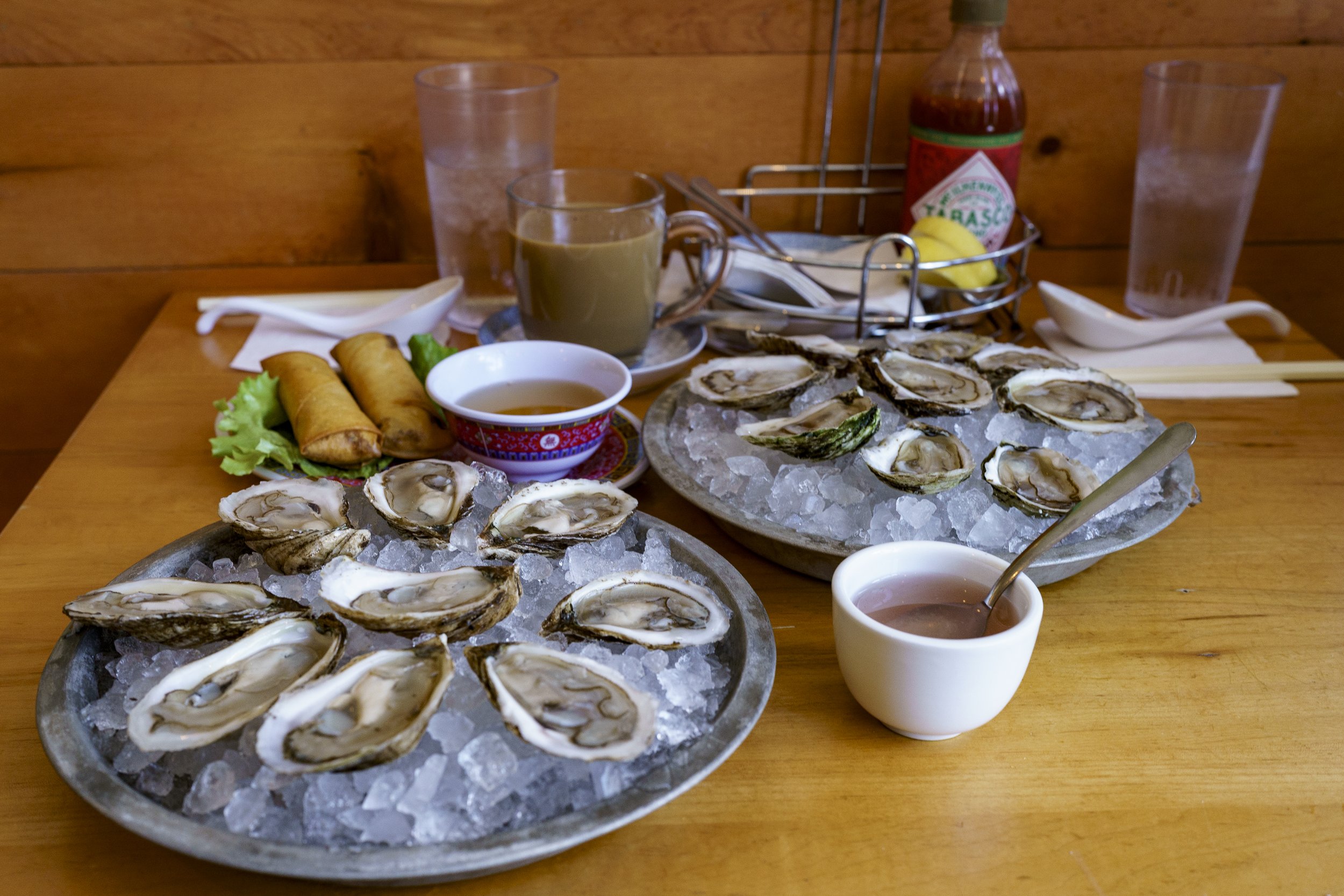  Oysters and fried spring rolls. The former is a fun addition to the Vietnamese restaurant and the latter is wrapped in rice rolls. Photo by Luke Best. 