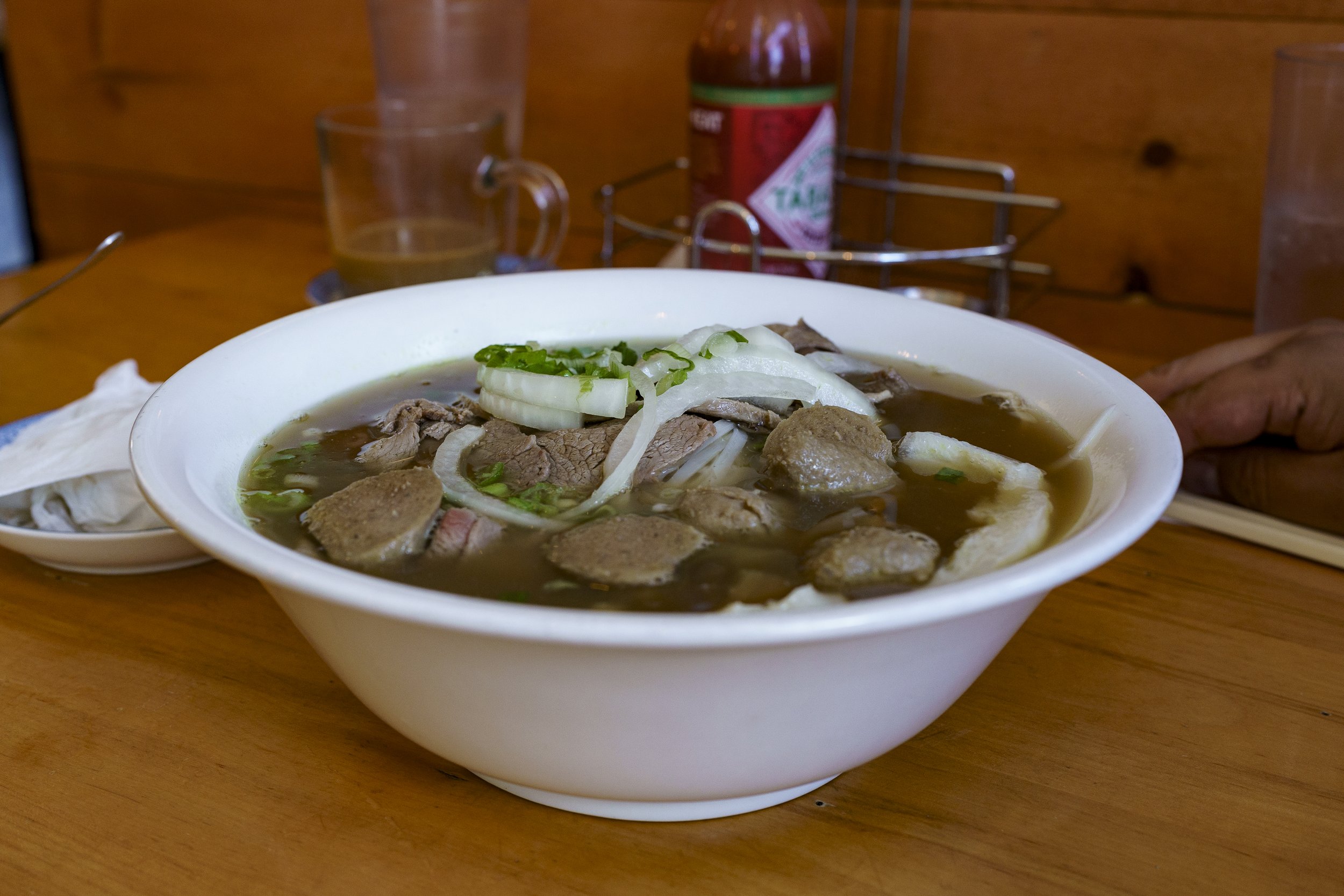  Pho is Vietnam’s national dish that consists of rice noodles and vegetable garnish in a beef broth. Several beef cuts included in the soup are flank, tendon, tripe, beef balls and tenderloin. Photo by Luke Best. 