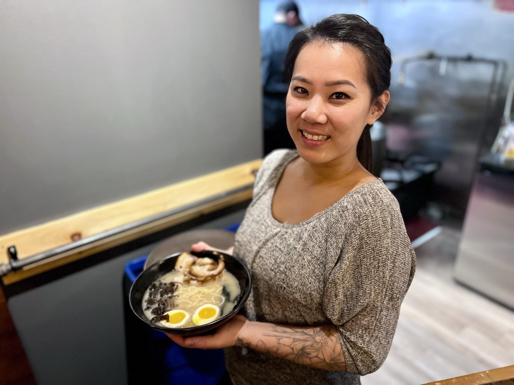 Owner Susan Tung holding a bowl of Shoyu Ramen consisting of ramen noodles, a soft-boiled egg, chashu pork, woodear mushrooms, bean sprouts and onions. All photos by David Tuan Bui.
