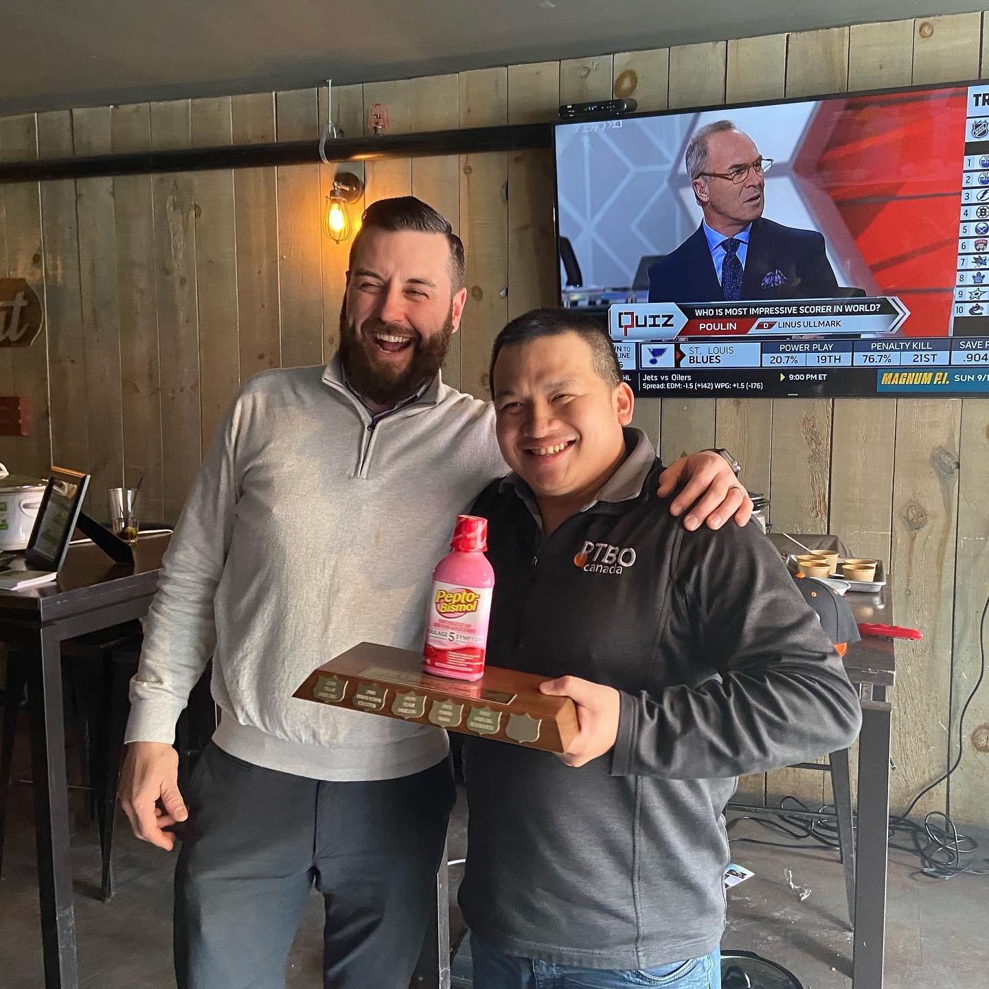 Brad Wood (left) and David Tuan Bui (right) winning the Pepto Bismol Chili Challenge trophy. The winning recipe was a maple bacon chili. Photo courtesy of Darling Insurance.