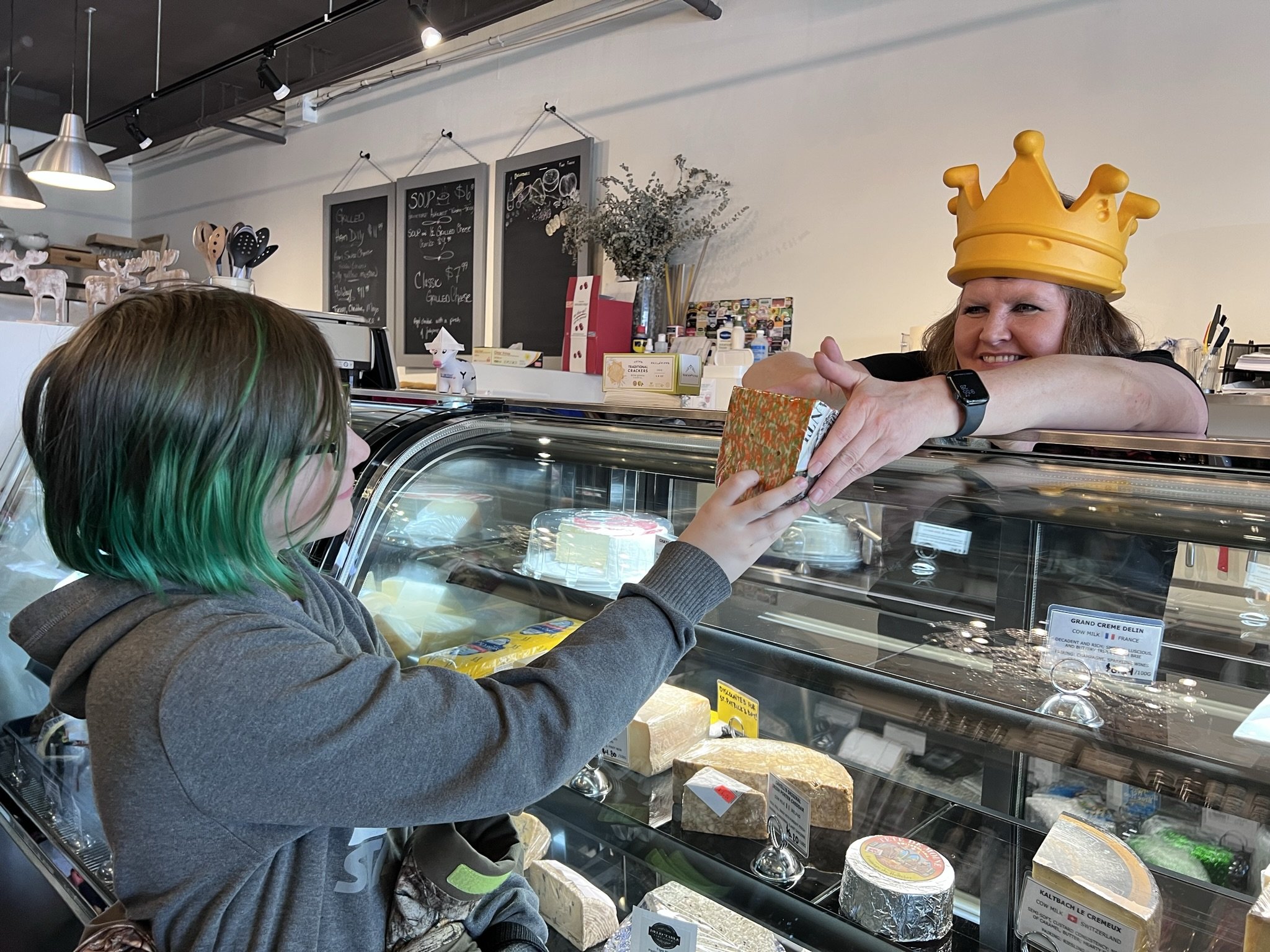 Eleven-year old Marcus Alldread (left) gets a peek at a uniquely-looking tricoloured gouda from Christel Rumgay, Delectable Fine Foods owner (right).All photos by David Tuan Bui.