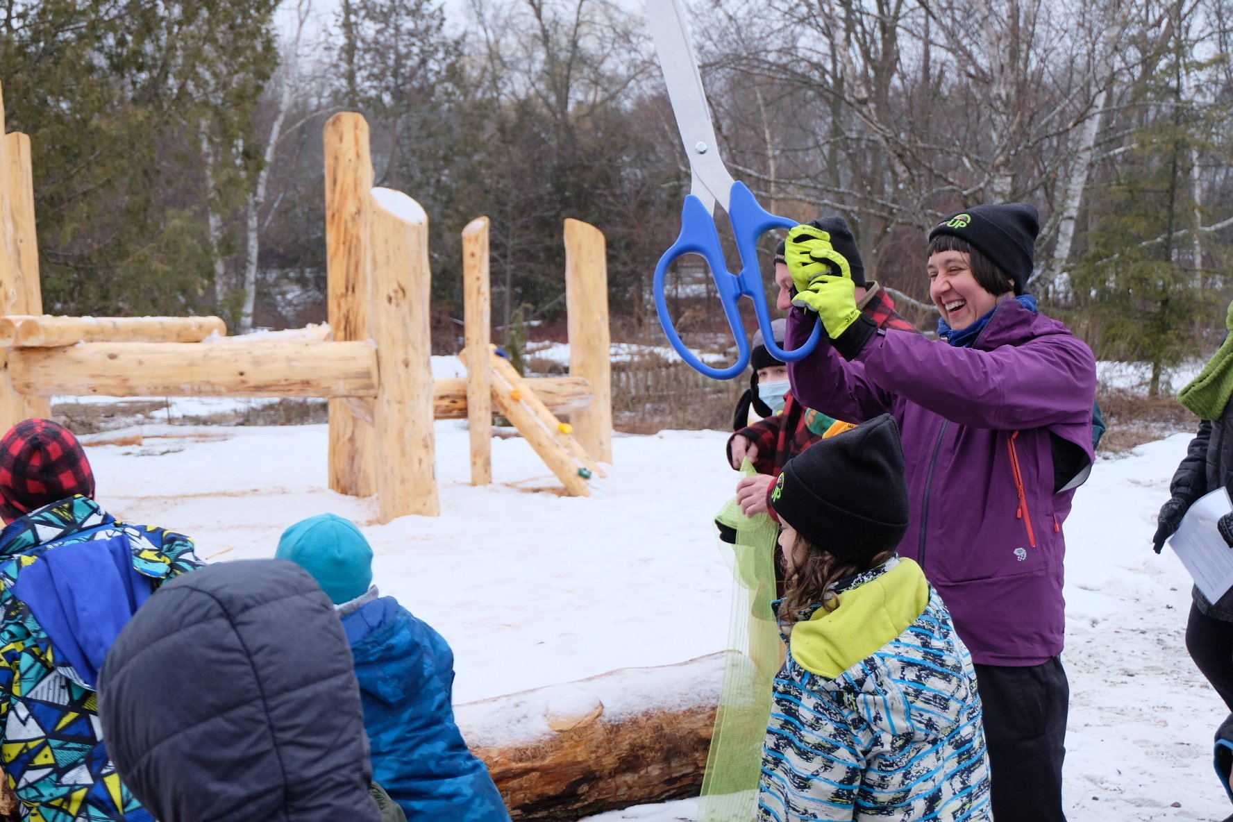  Tegan Moss, executive director at GreenUP, cuts the ribbon to signify the opening of the Peterborough's first naturalized playscape on public grounds at Ecology Park, to the excitement of the many children who then ran onto use the playscape. Photo 